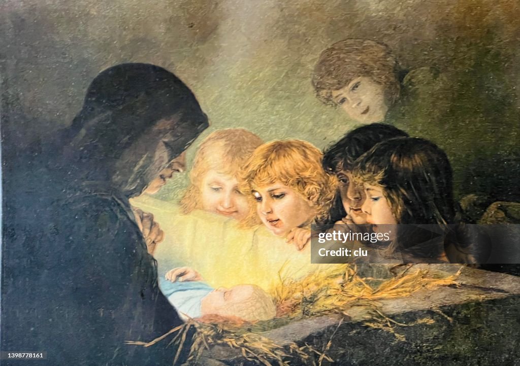 Children look into the golden nativity scene