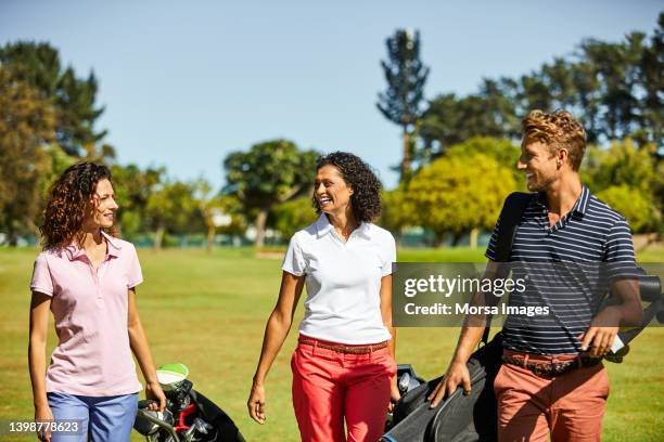 happy golfers at golf course during sunny day - professional golfer stock pictures, royalty-free photos & images