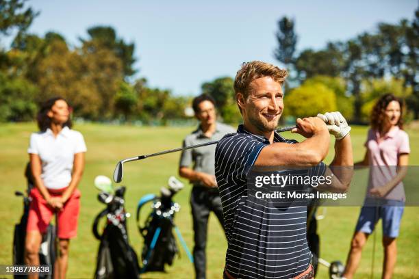 golfer practicing at golf course in summer - young men golfing stock pictures, royalty-free photos & images