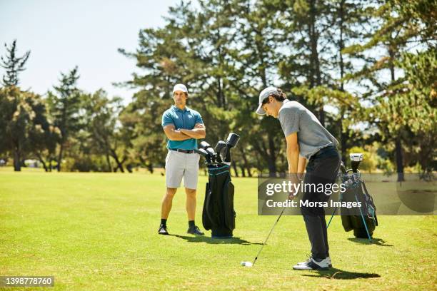 male golfers playing on golf course in summer - professional golfer stock pictures, royalty-free photos & images