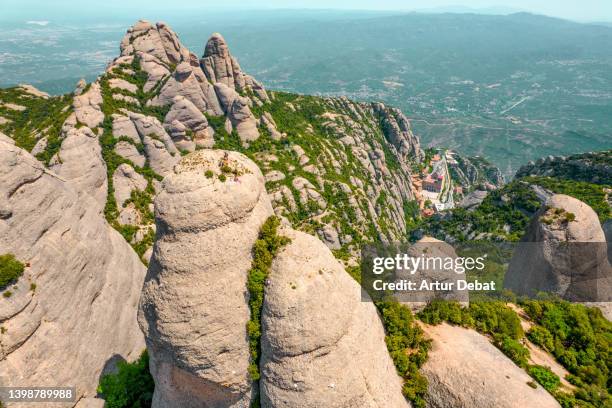 drone picture above group of climbers on the top of a mountain peak spire in montserrat. spain. - monserrat mountain stock pictures, royalty-free photos & images