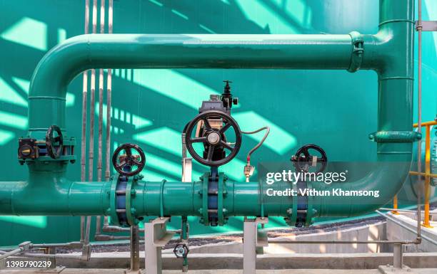 valves and pipeline system of industrial zone, steel pipeline and valves at factory, pump and motor which popular to install with pipe in industrial such chemical, power plant, oil and gas. - air valve fotografías e imágenes de stock