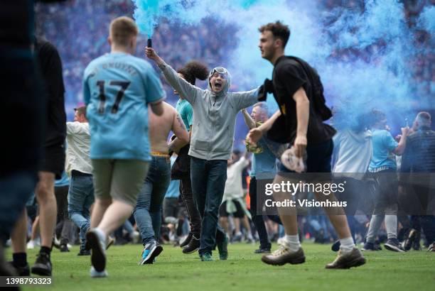 Manchester City fans invade the pitch after the Premier League match between Manchester City and Aston Villa at Etihad Stadium on May 22, 2022 in...