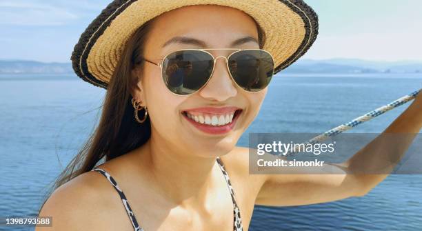 woman standing on sailboat - hoop earring stock pictures, royalty-free photos & images