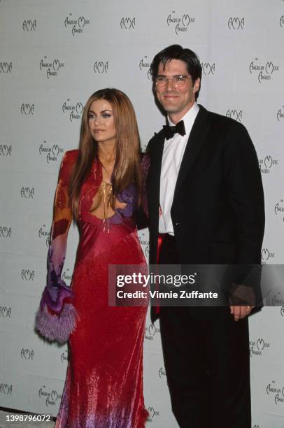 American actress, model and television personality Carmen Electra, wearing a red-and-lilac evening gown, and American actor Thomas Gibson in the...