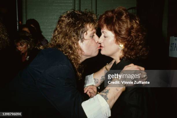 British singer and songwriter Ozzy Osbourne kisses his British manager and wife, Sharon Osbourne, circa 1985