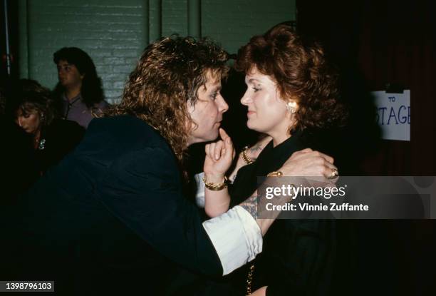 British singer and songwriter Ozzy Osbourne goes face-to-face with his British manager and wife, Sharon Osbourne, his hands on her shoulders at an...