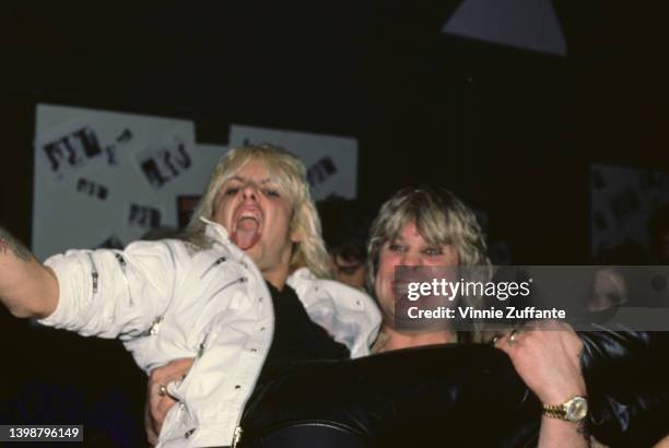 British singer and songwriter Ozzy Osbourne carries American singer and musician Vince Neil at the after party following a concert date on Osbourne's...