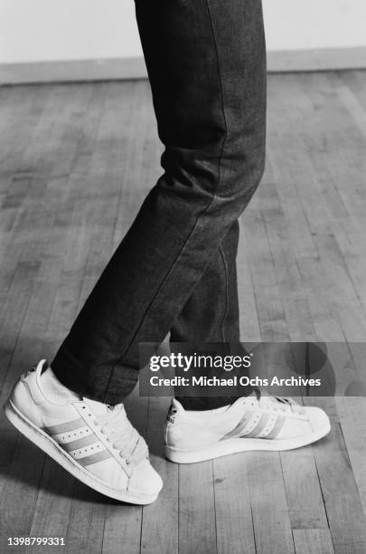 Breakdancer wearing adidas superstar trainers, performing a moonwalk, United States. Circa 1980.