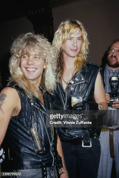 American drummer and songwriter Steven Adler and American guitarist and songwriter Duff McKagan, both in black leather waistcoats, attend an event,...