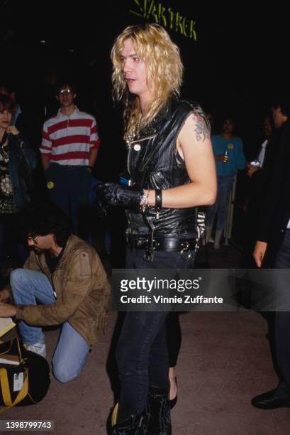 American guitarist and songwriter Duff McKagan, wearing a black leather waistcoat, attends an event, United States, circa 1990.