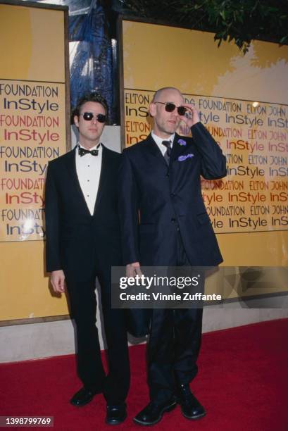 American singer and songwriter Michael Stipe and a man, both wearing sunglasses, attend the Elton John AIDS Foundation and InStyle Oscar Party in Los...