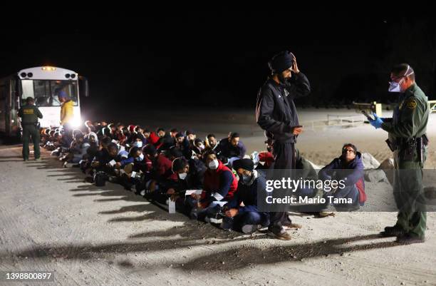 Immigrants from India wait to board a U.S. Border Patrol bus to be taken for processing after crossing the border from Mexico on May 22, 2022 in...