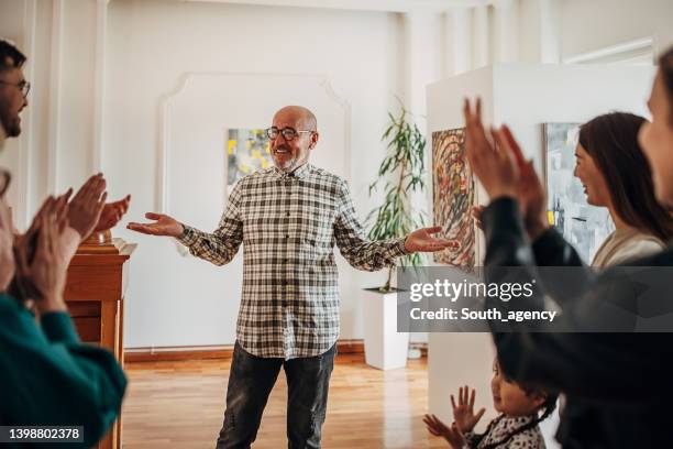 people at gallery opening - parents applauding stock pictures, royalty-free photos & images