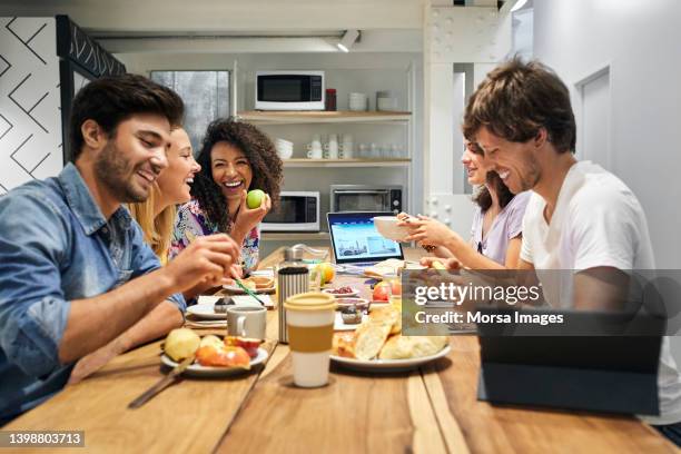 happy friends enjoying breakfast during vacation - hostel stock pictures, royalty-free photos & images