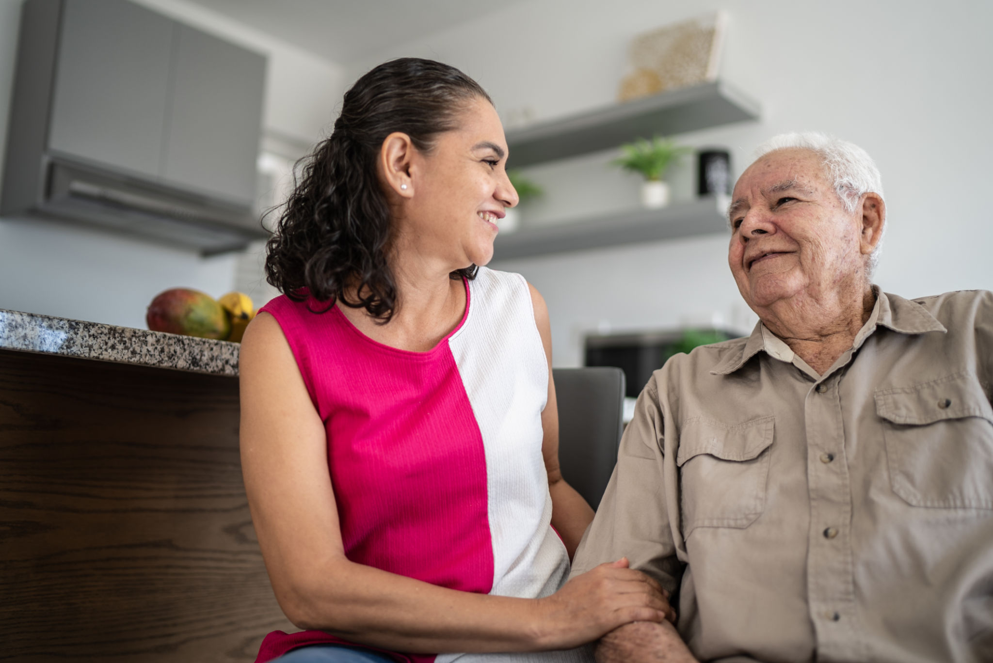 Senior man and his daughter (or home caregiver) talking at home Senior man and his daughter (or home caregiver) talking at home