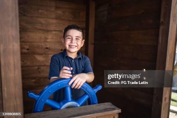 portrait of boy playing with rudder outdoors - rudder stock pictures, royalty-free photos & images