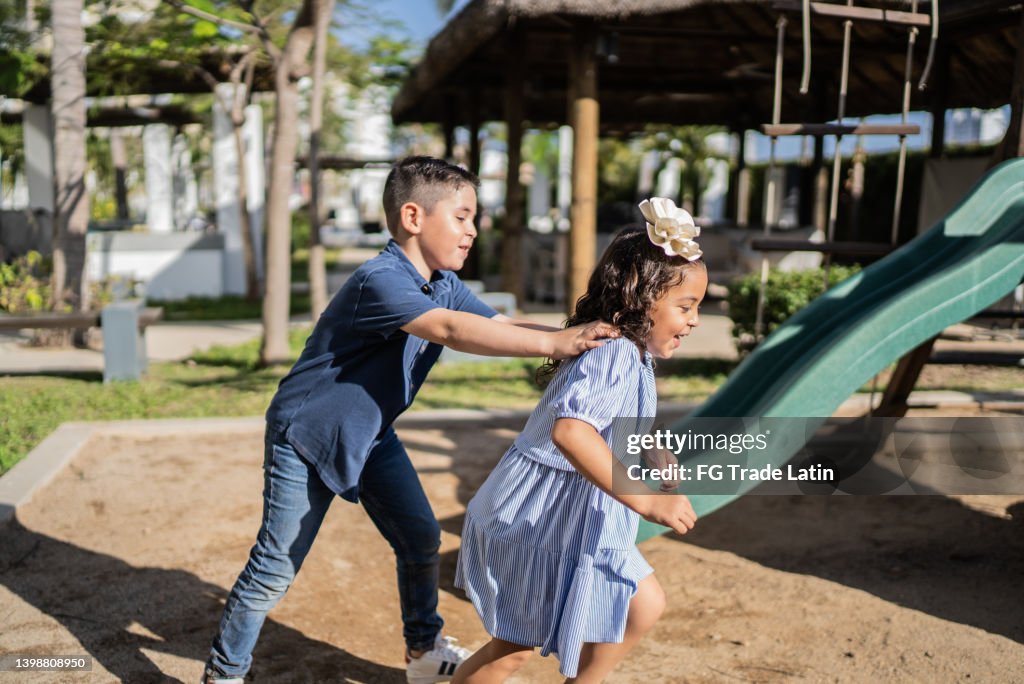 Siblings playing on a playground