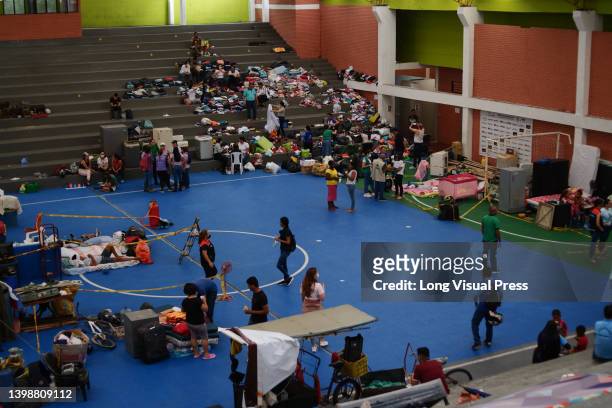 People seek shelter at a sports stadium as people of Villavicencio, Colombia react and stay in shelters after the Guatiquia river overflowed its...
