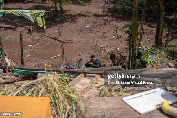 Man helps clean debris as people of Villavicencio, Colombia react and stay in shelters after the Guatiquia river overflowed its banks due to rains...