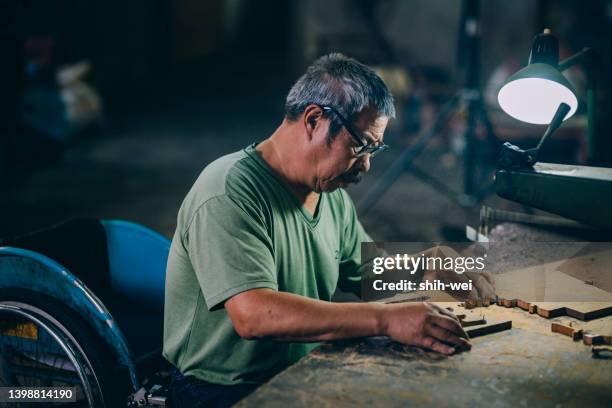 the daily life of a disabled woodcarver - disability choicepix stock pictures, royalty-free photos & images