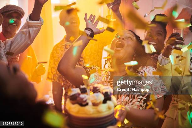 a group of extended family and friends socialising together. - older woman birthday stock pictures, royalty-free photos & images