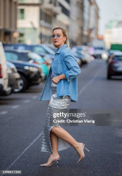 Tina Haase is seen wearing Rabens Saloner silver metallic bandeau dress, Baum & Pferdgarten light blue denim shirt, Mango crystal vinyl heels on May...