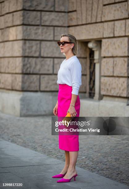 Tina Haase is seen wearing Ganni white logo longsleeve, Zara pink midi skirt and pink mules, Fendi orange monogrammed clutch bag , Celine sunglasses...