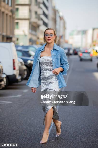 Tina Haase is seen wearing Rabens Saloner silver metallic bandeau dress, Baum & Pferdgarten light blue denim shirt, Mango crystal vinyl heels on May...