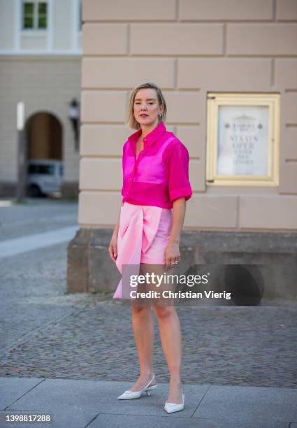 Tina Haase is seen wearing Apparis pink organza shirt, Zara babypink Mini skirt, Prada Slingback heels on May 22, 2022 in Berlin, Germany.