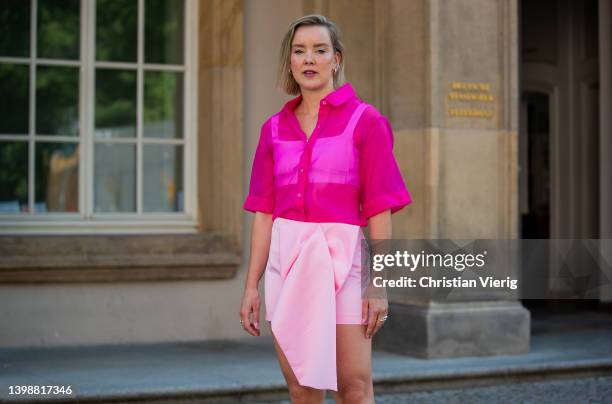 Tina Haase is seen wearing Apparis pink organza shirt, Zara babypink Mini skirt, Prada Slingback heels on May 22, 2022 in Berlin, Germany.