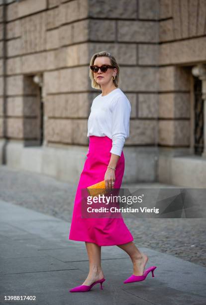 Tina Haase is seen wearing Ganni white logo longsleeve, Zara pink midi skirt and pink mules, Fendi orange monogrammed clutch bag , Celine sunglasses...