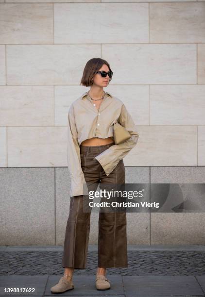 Jacqueline Zelwis is seen wearing ONWEEKENDS Cropped button shirt, brown Gestuz leather pants Oysho shoes, House of Dagmar sunglasses, Olito bag on...