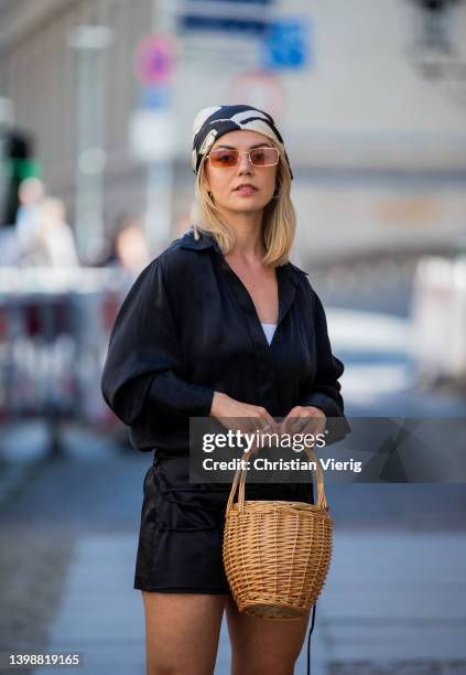 Amelie Stanescu wearing Skirt Zara, Shirt InWear, Knit tank top Sézane, head scarf, Shoes Givenchy, basket bag on May 22, 2022 in Berlin, Germany.