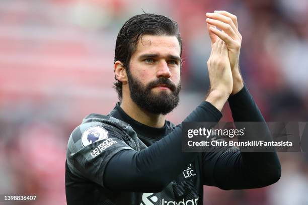 Alisson of Liverpool applauds the supporters at full-time following the Premier League match between Liverpool and Wolverhampton Wanderers at Anfield...