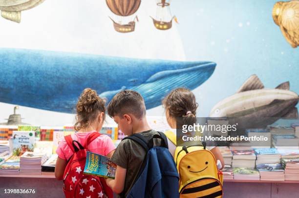 Children watching books at the Turin Book Fair. Turin , May 19th, 2022