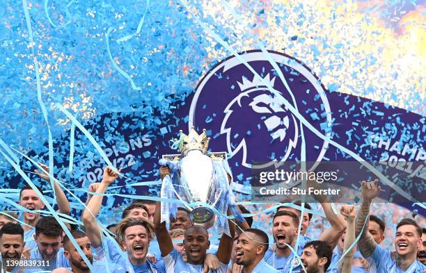 Manchester City captain Fernandinho lifts the Premier League Trophy and celebrates with the squad after the Premier League match between Manchester...