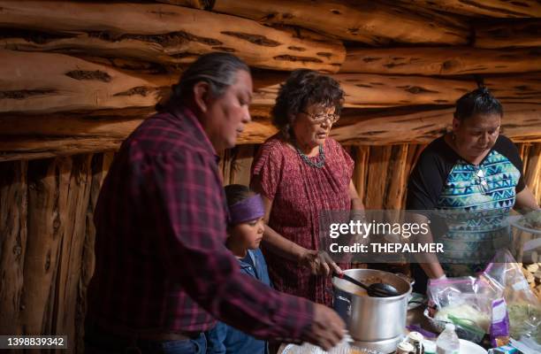 family offering a traditional navajo taco dinner to guests inside their hogan - cooking chili stock pictures, royalty-free photos & images