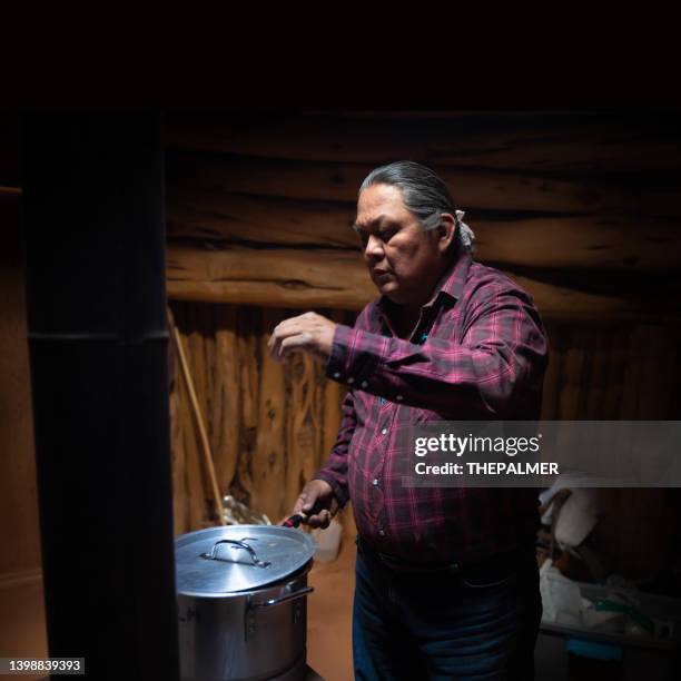 cooking a chilly bean filling for navajo tacos in a traditional hogan - american tribal culture stock pictures, royalty-free photos & images