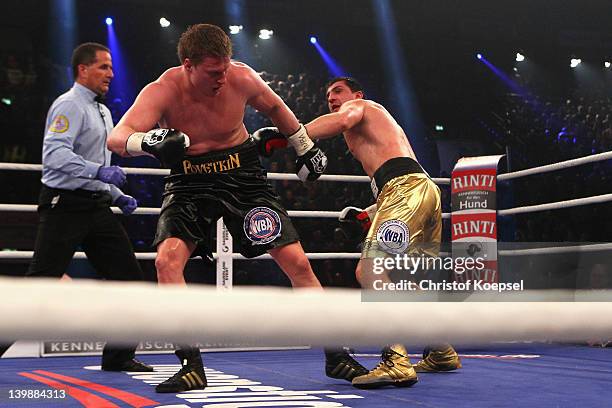 Marco Huck of Germany punches Alexander Povetkin of Russia celebrates the victory afterduring the WBA World Championship Heavyweight fight between...