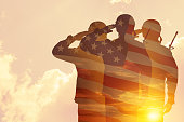 Silhouettes of soldiers with print of sunset. Greeting card for Veterans Day, Memorial Day, Independence Day.