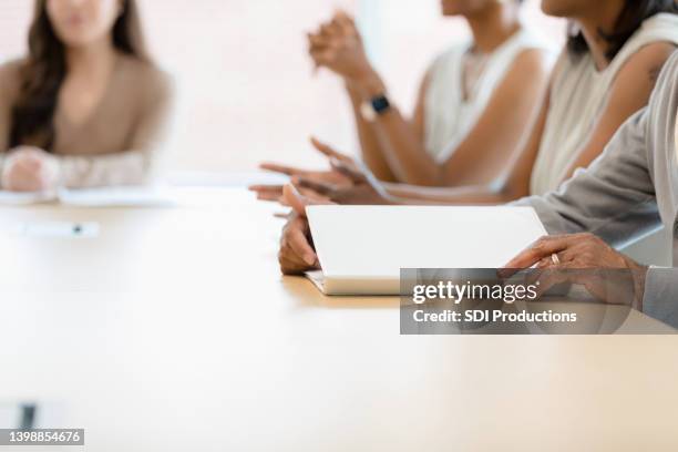 unrecognizable group of diverse people meet around table - meeting table stock pictures, royalty-free photos & images