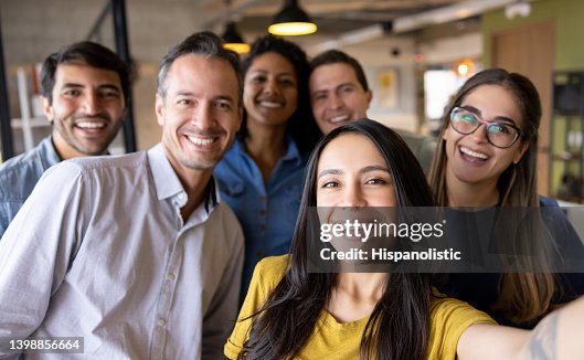 Happy group of coworkers taking a selfie at the office Happy group of coworkers taking a selfie at the office