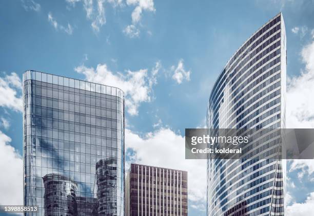 glass and steel skyscrapers against blue sky - la defense bildbanksfoton och bilder