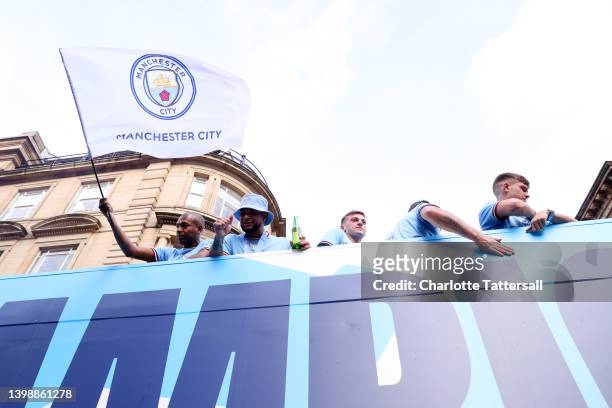Fernandinho of Manchester City waves a flag to the fans during the Manchester City FC Victory Parade on May 23, 2022 in Manchester, England.