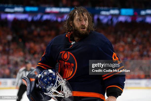 Goaltender Mike Smith of the Edmonton Oilers skates off after being hit by Milan Lucic of the Calgary Flames during the third period in Game Three of...