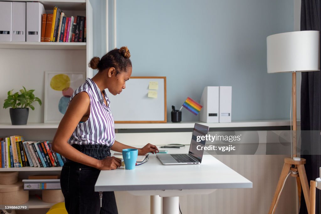 Young Woman Working At Standing Desk