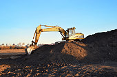 Excavator on earthmoving during construction. Loader at open pit mining. Excavator digs gravel in quarry.