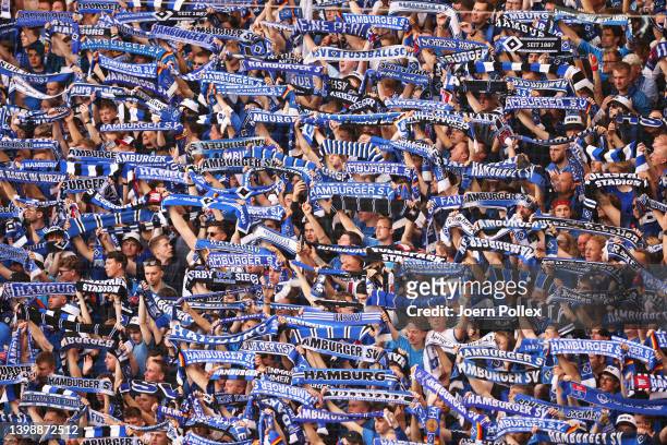 Hamburg SV fans hold scarves during the Bundesliga Playoffs Leg Two match between Hamburger SV and Hertha BSC at Volksparkstadion on May 23, 2022 in...