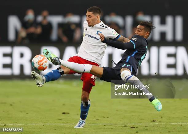 Kevin-Prince Boateng of Hertha Berlin challenges Ludovit Reis of Hamburger SV during the Bundesliga Playoffs Leg Two match between Hamburger SV and...